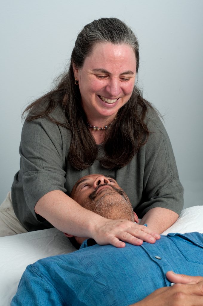Massage therapist Cindy Bloom messaging a patient.